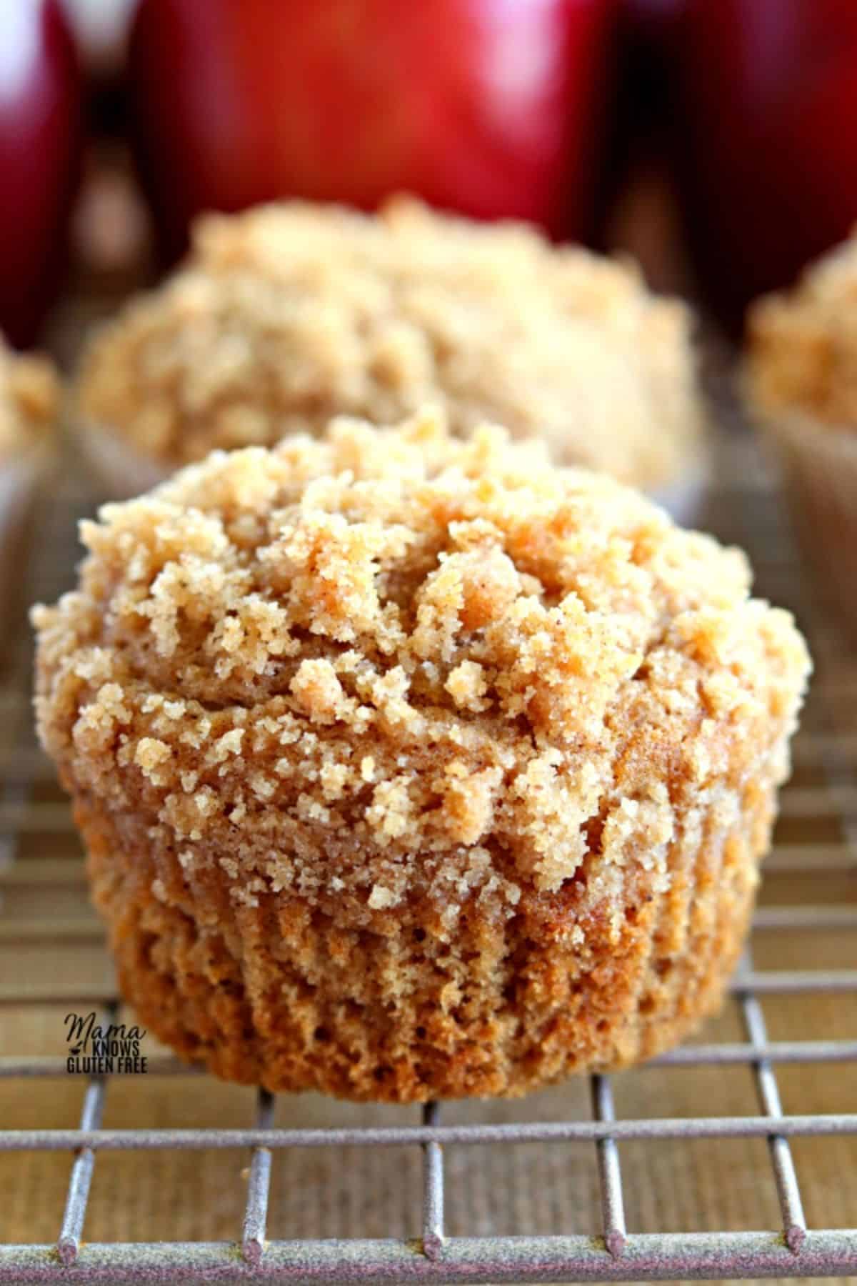 Delicious Gluten-Free Apple Cinnamon Crumb Muffins on a resting grid.