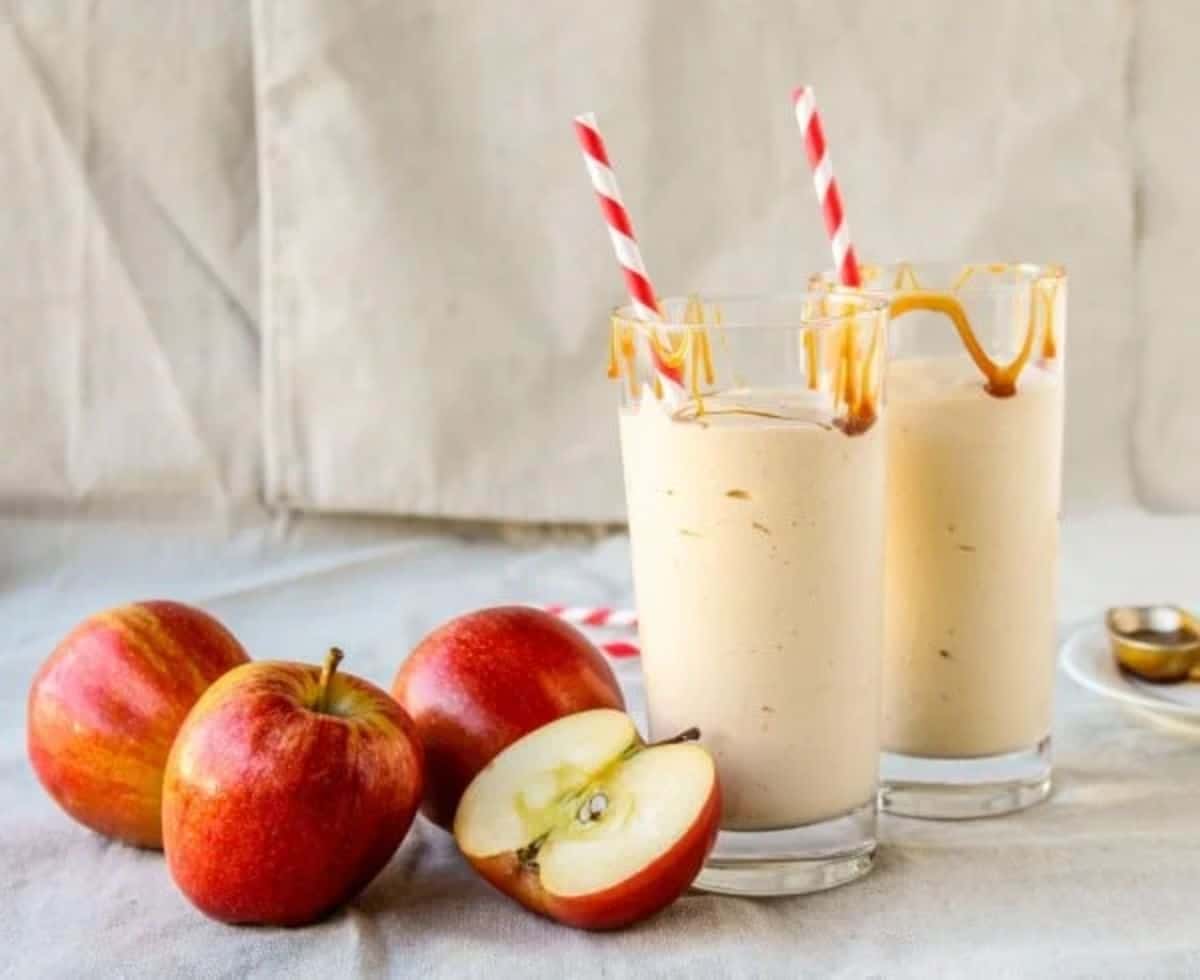 Caramel Apple Cider Reduction Shakes in glass cups with straws.