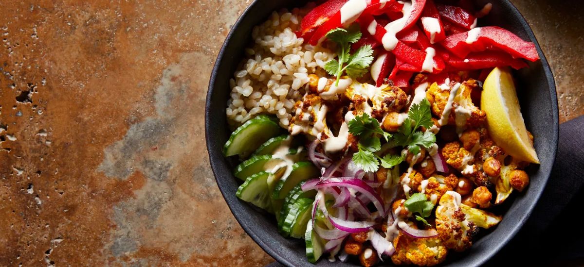 Vegan Shawarma with Roasted Cauliflower and Chickpeas in a black bowl.