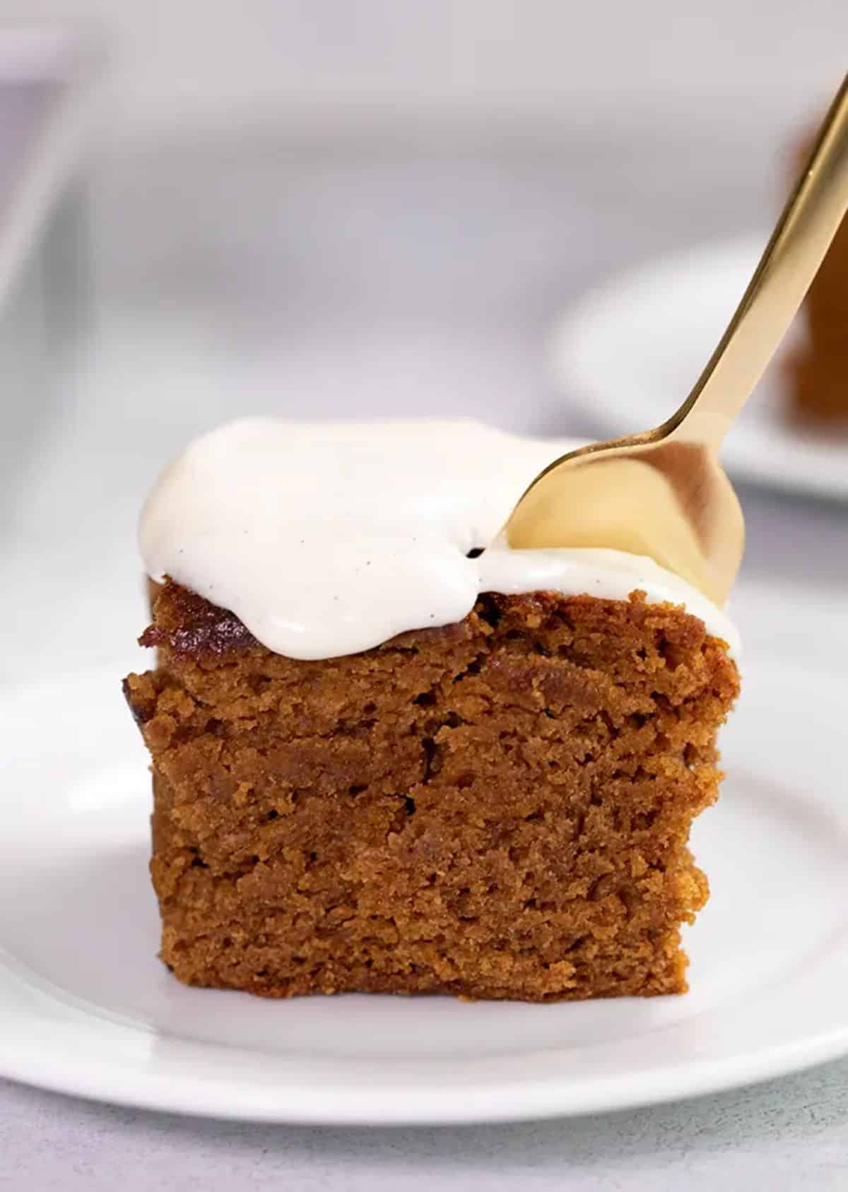 A piece of scrumptious Gluten-Free Gingerbread Cake on a white plate.