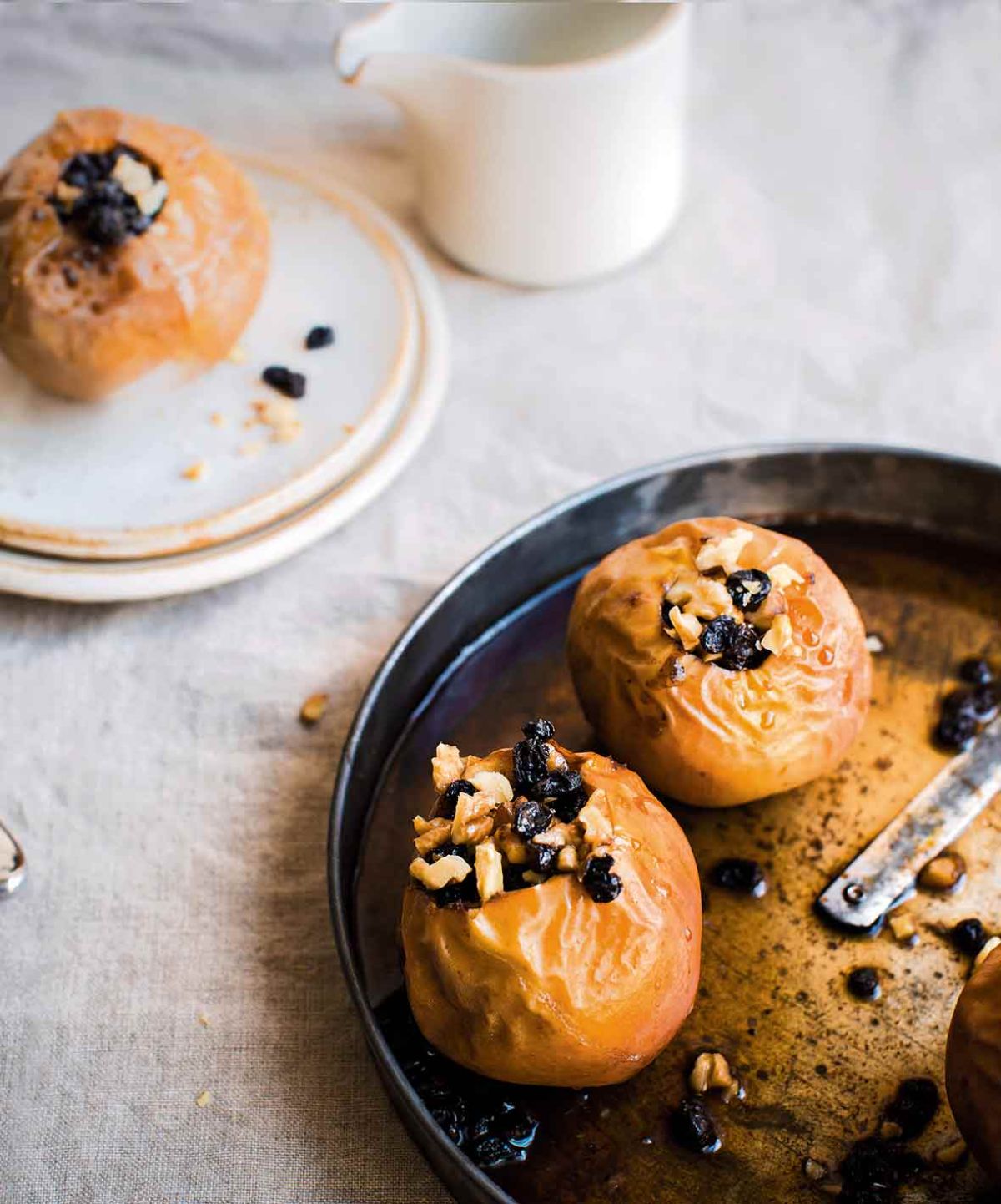 Delicious gluten-free Baked Apples With Coconut Cream on a black tray.