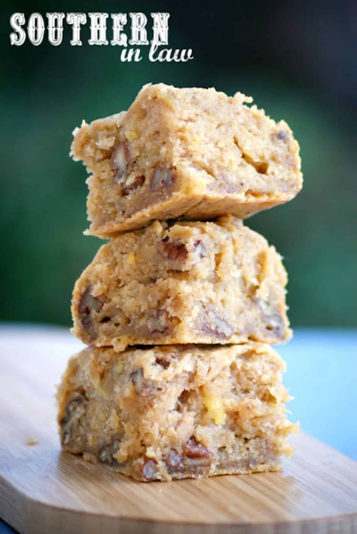 A pile of Healthy Vegan Banana Blondies on a wooden tray.