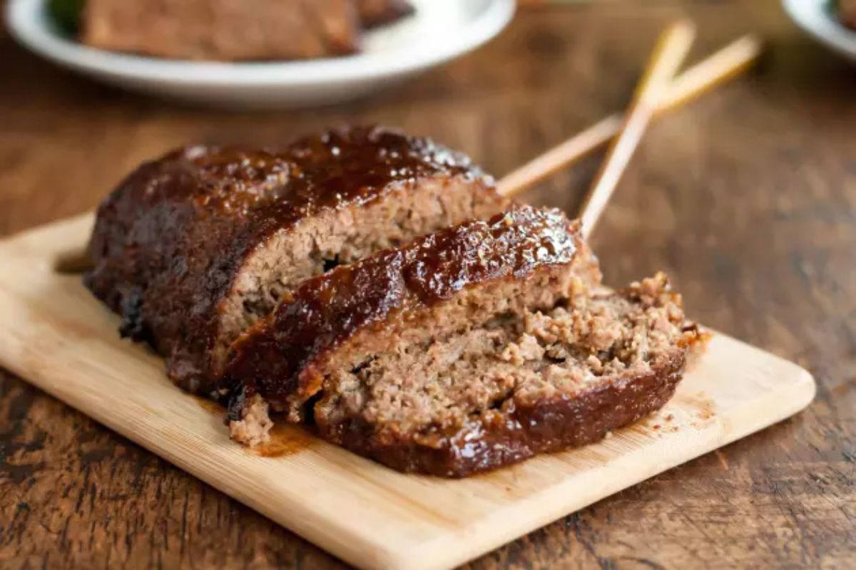 Sliced Gluten-Free Teriyaki Meatloaf on a wooden cutting board.