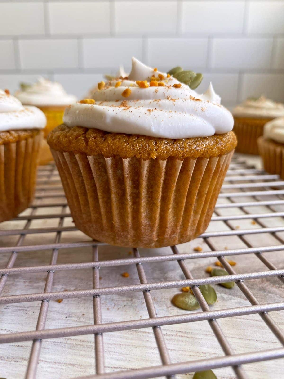 Delicious Cassava Flour Pumpkin Cupcakes on a resting grid.