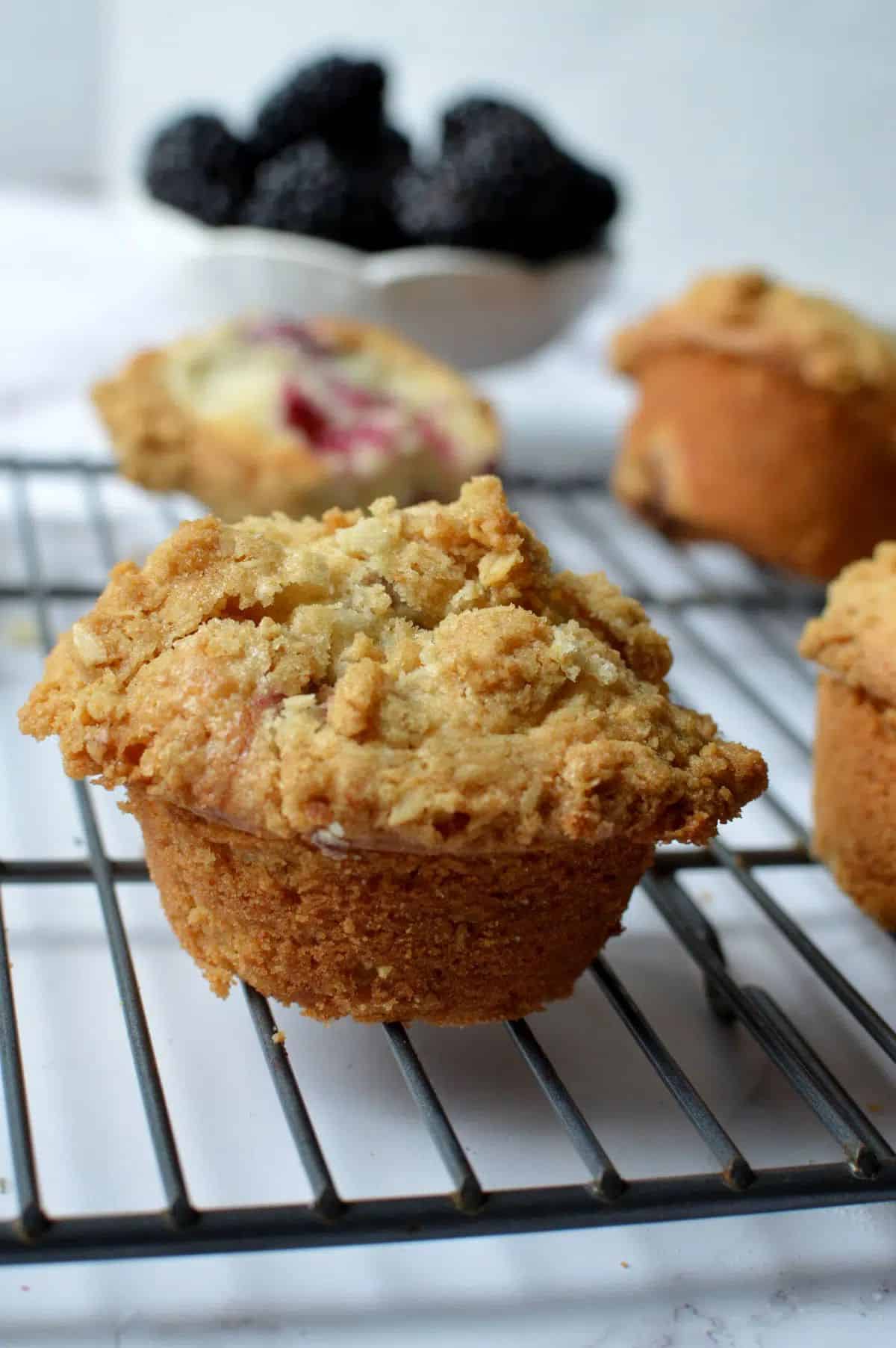 Delicious Gluten-Free Blackberry Muffins on a resting grid.