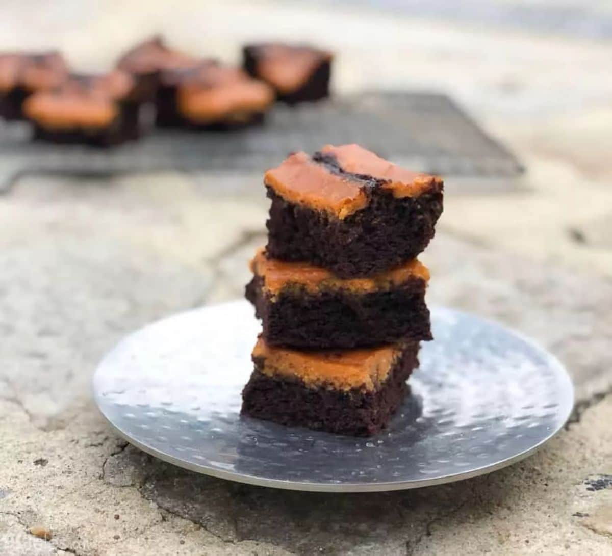 A pile of Gluten-Free Pumpkin Brownies on a gray plate.