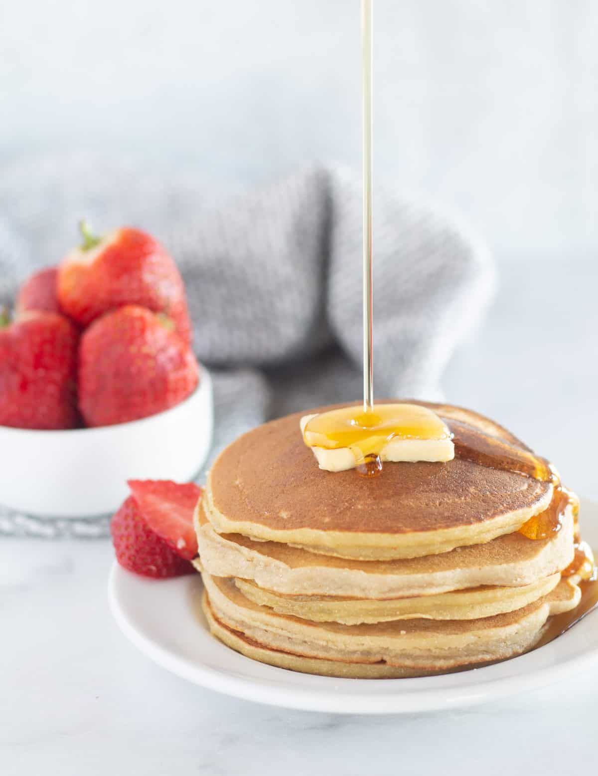 A pile of delicious Cassava Flour Pancakes on a white plate.