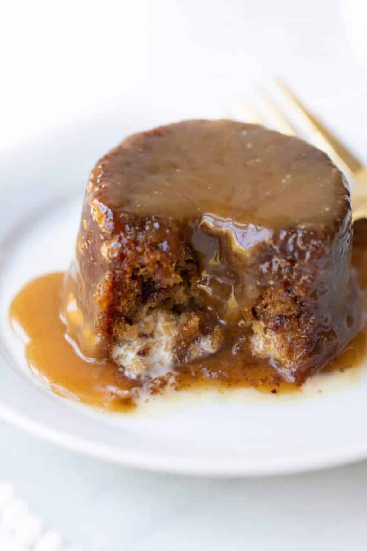 Delicious Gluten-Free Sticky Toffee Pudding Cake on a white plate.
