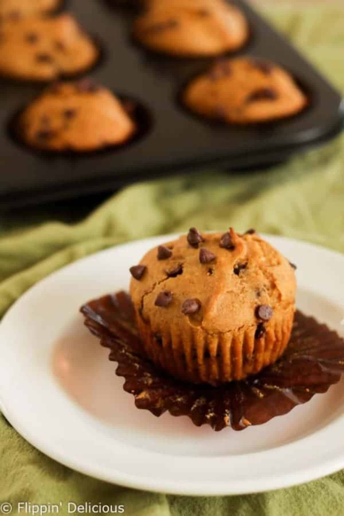 A delicious Pumpkin Muffin on a white plate.