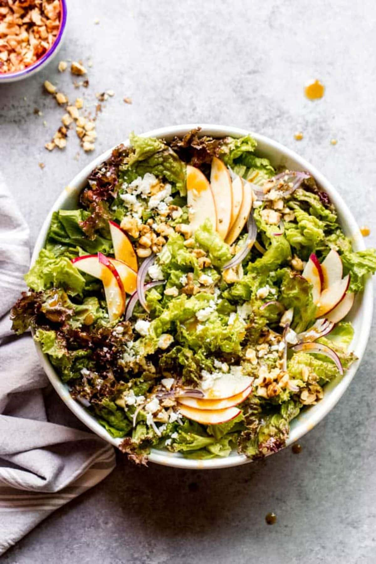 Apple Walnut Salad with Balsamic Vinaigrette in a white bowl.