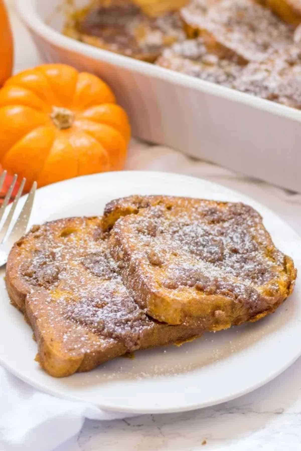 Two Pumpkin Spice French Toasts on a white plate.