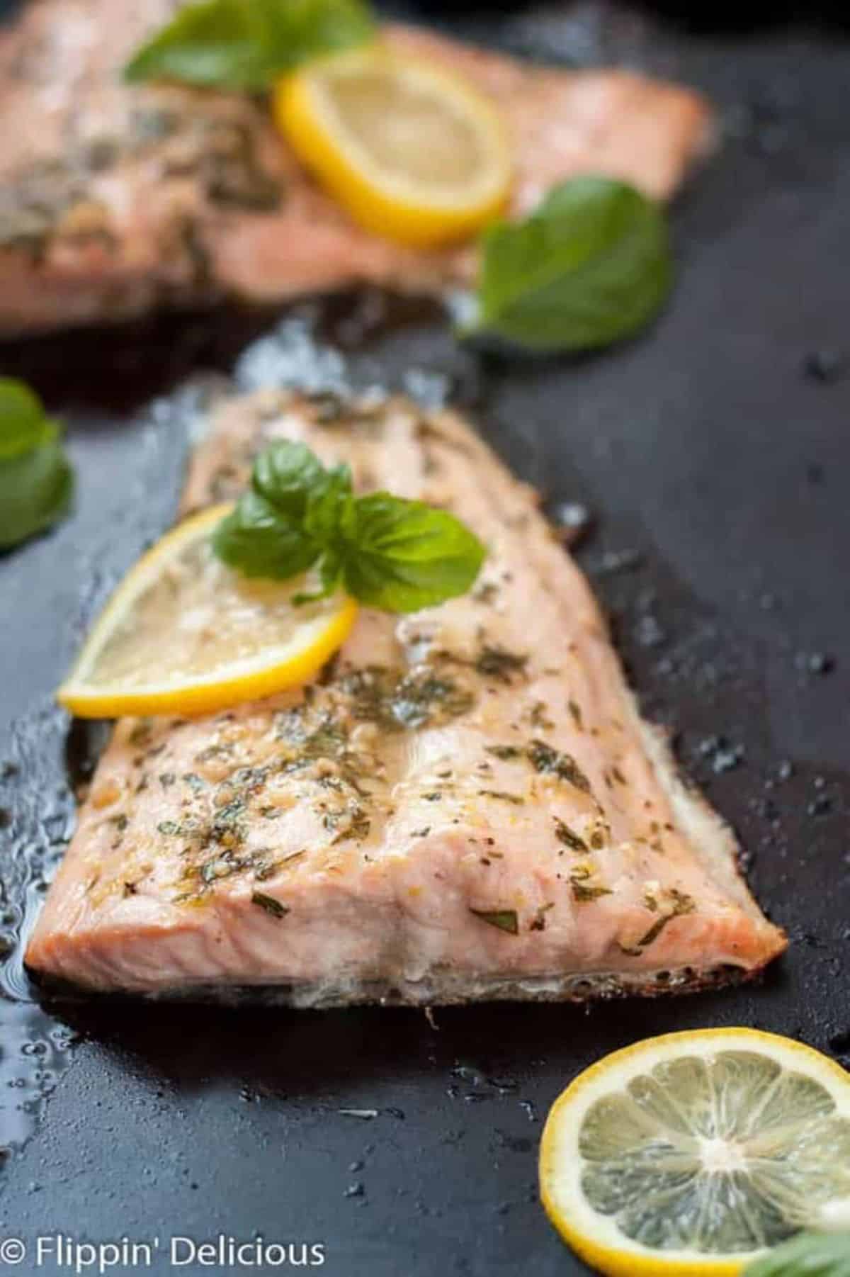 Lemon Basil Salmon on a black skillet.