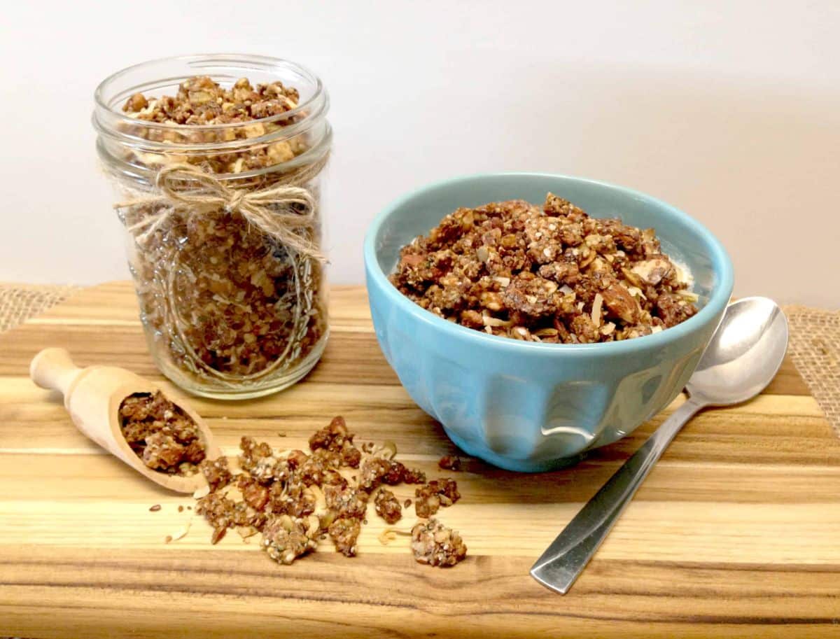 Coconut Granola in a glass jar and in a blue bowl.