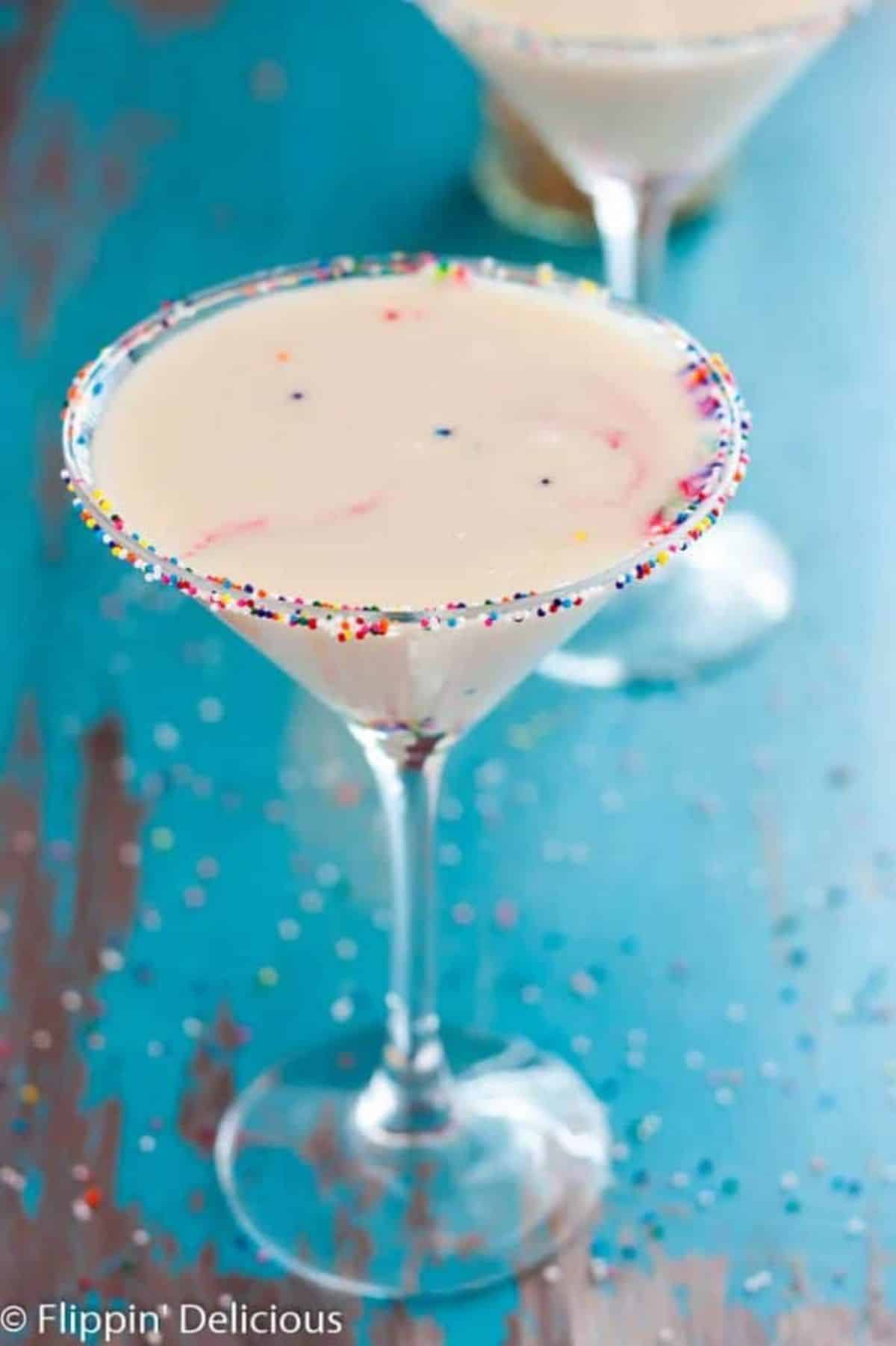 Dairy-Free Funfetti Martini in a tall glass.