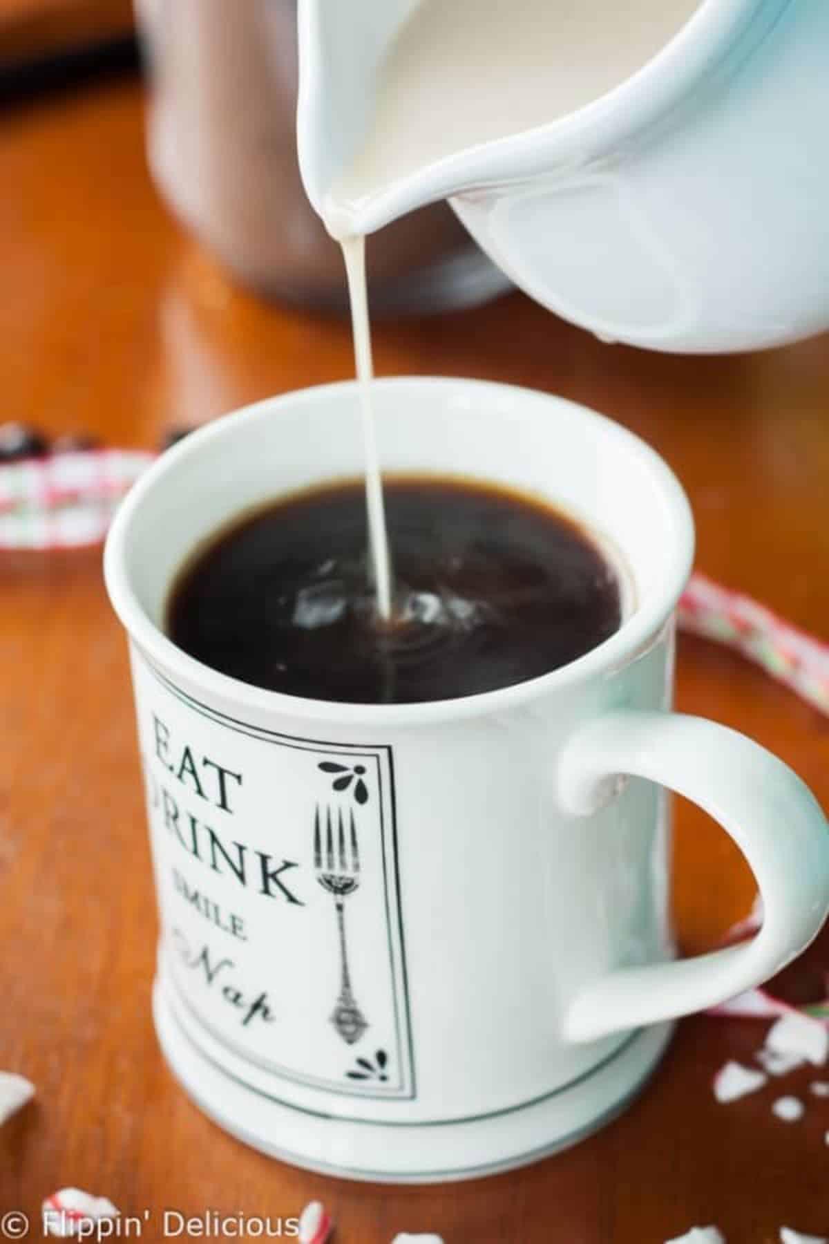 Dairy-Free Chocolate Peppermint Creamer poured into a cup with drink.
