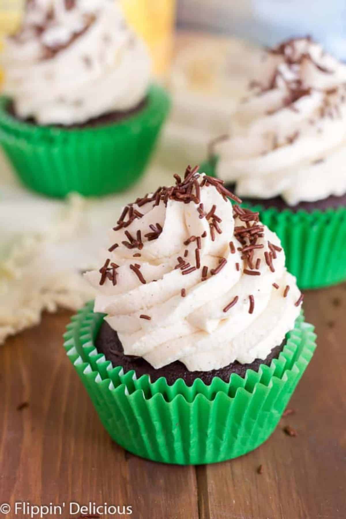 Delicious Gluten-Free Irish Cream Cupcakes on a wodoen table.