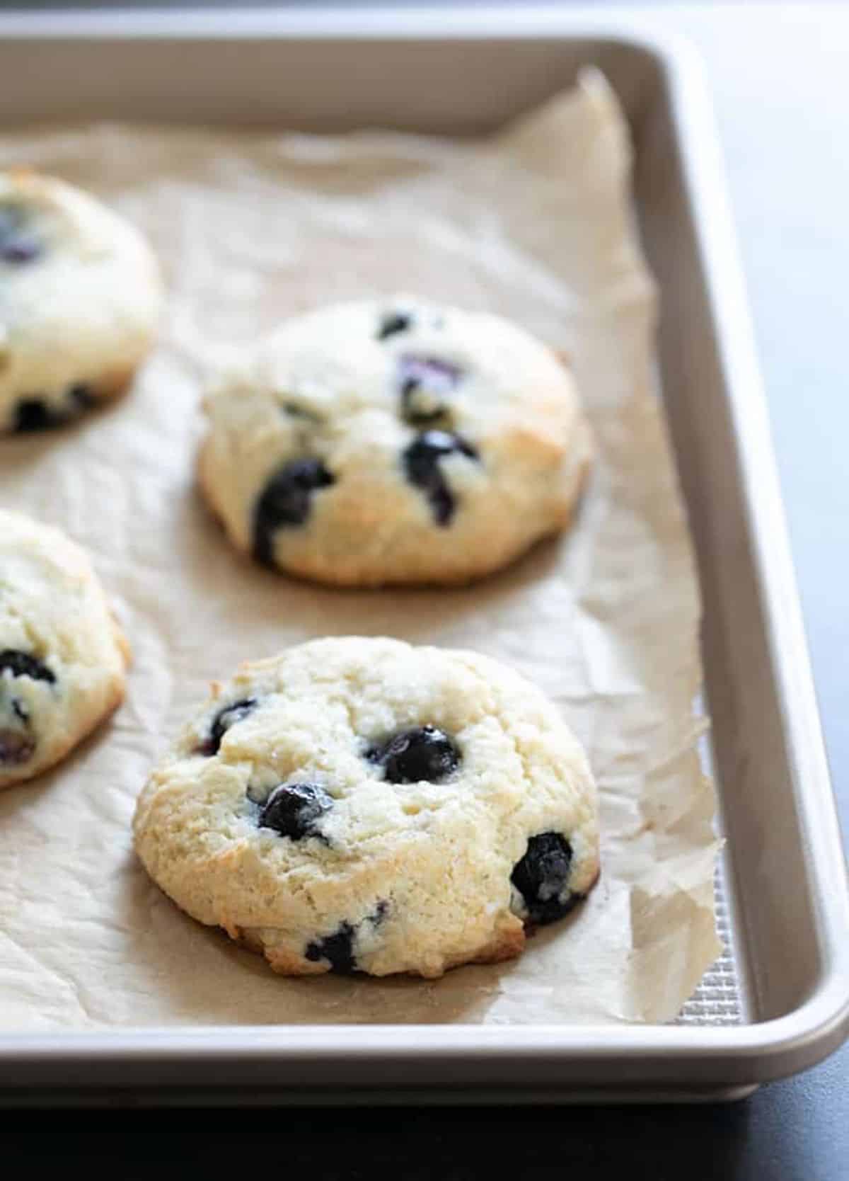 Gluten-Free Blueberry Muffin Tops on a baking tray.