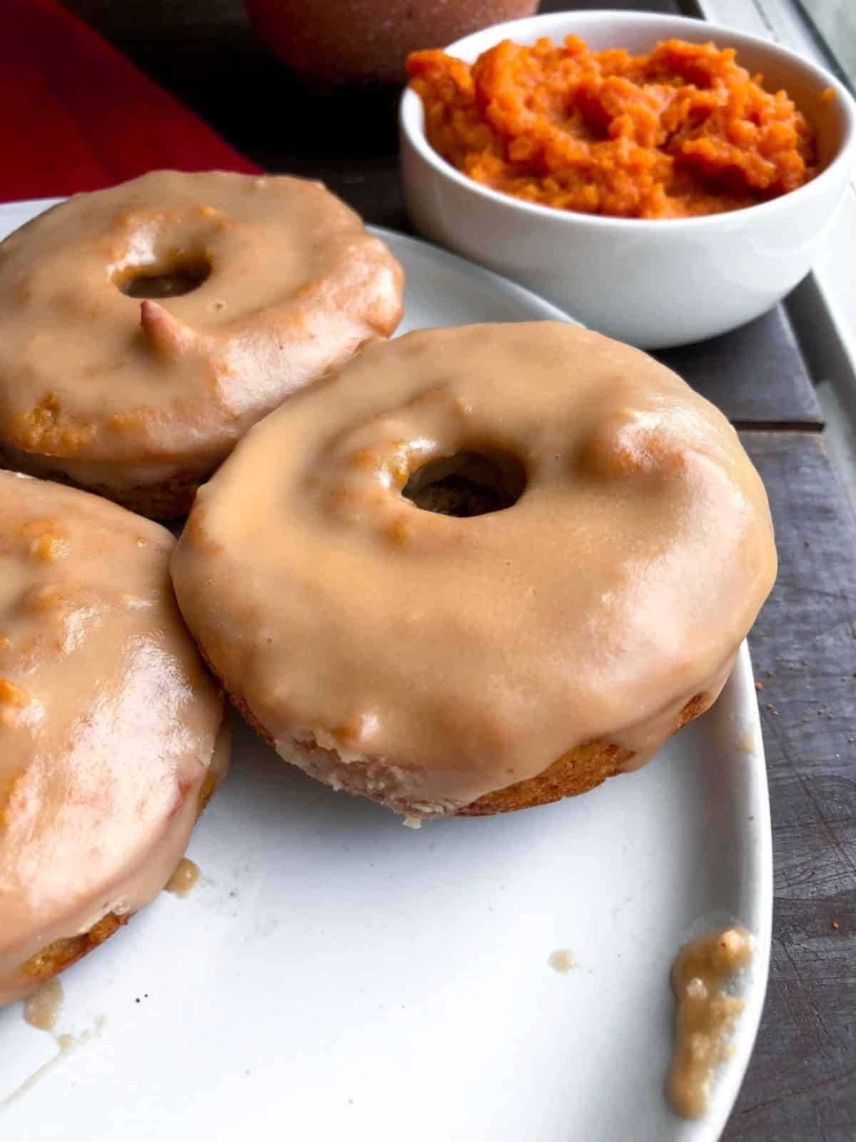 A delicious Paleo Pumpkin Donuts on a white tray.