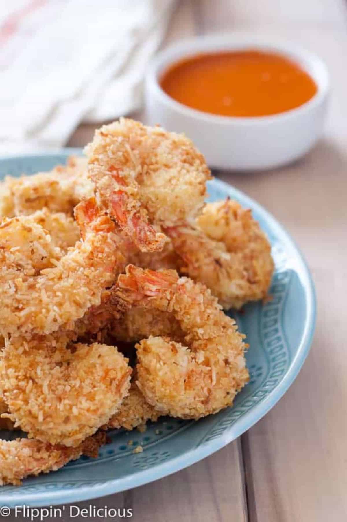 Crispy Gluten-Free Coconut Shrimps on a blue plate.
