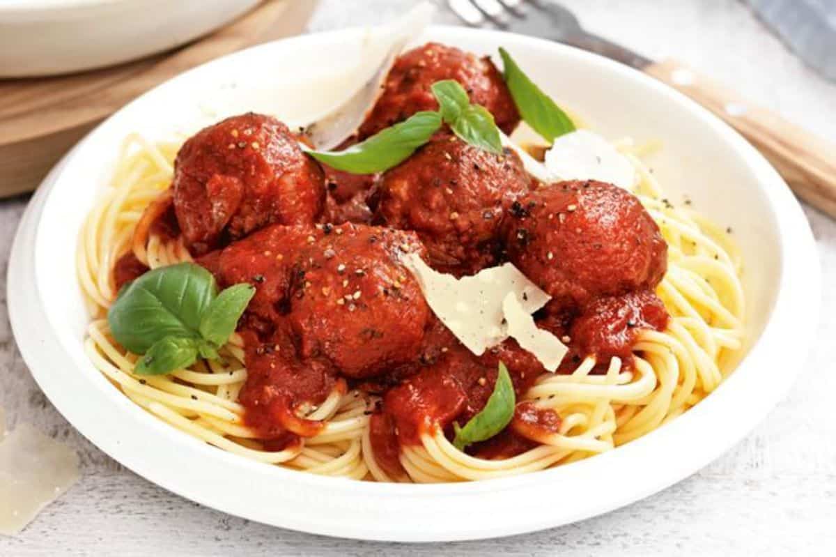 Gluten-Free Italian Meatballs and Spaghetti on a white plate.