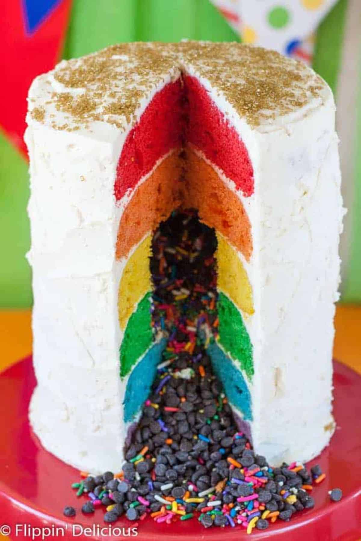 Mouth-watering Rainbow Layer Cake on a red cake tray.