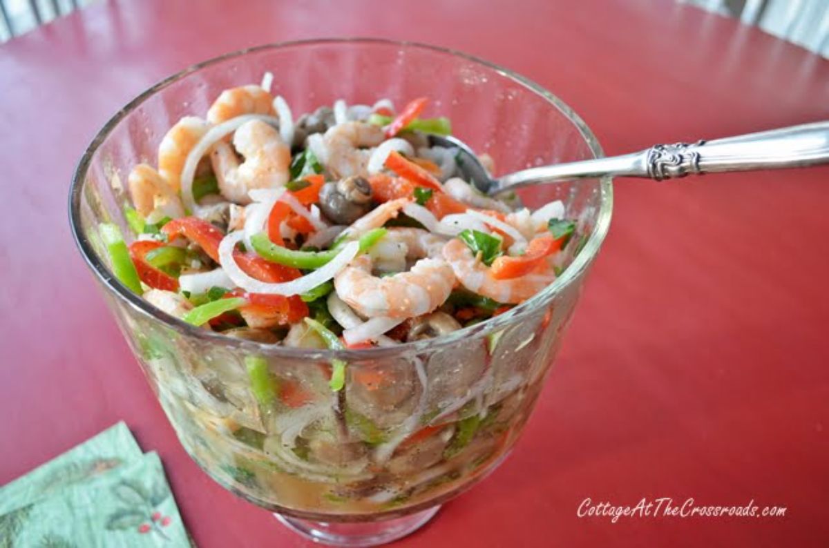 Delicious Marinated Shrimp in glass cup with a spoon.