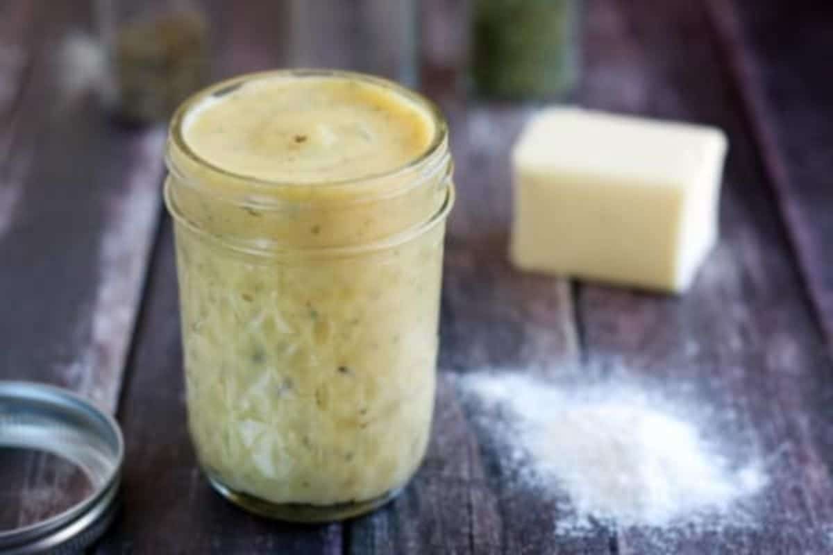 Gluten-Free Cream Of Chicken Soup in a glass jar on a wooden table.