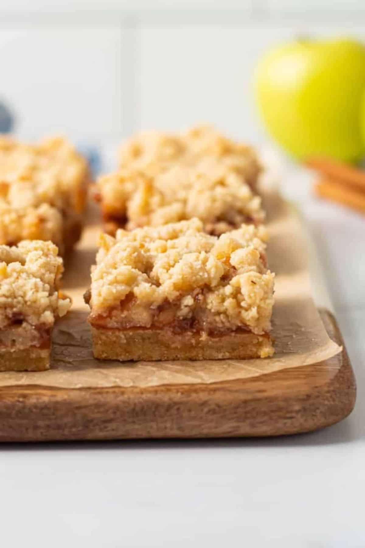 Gluten-Free Apple Pie Bars on a wooden tray.