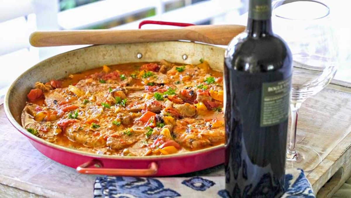 Spanish Pork and Sausage in a red skillet.