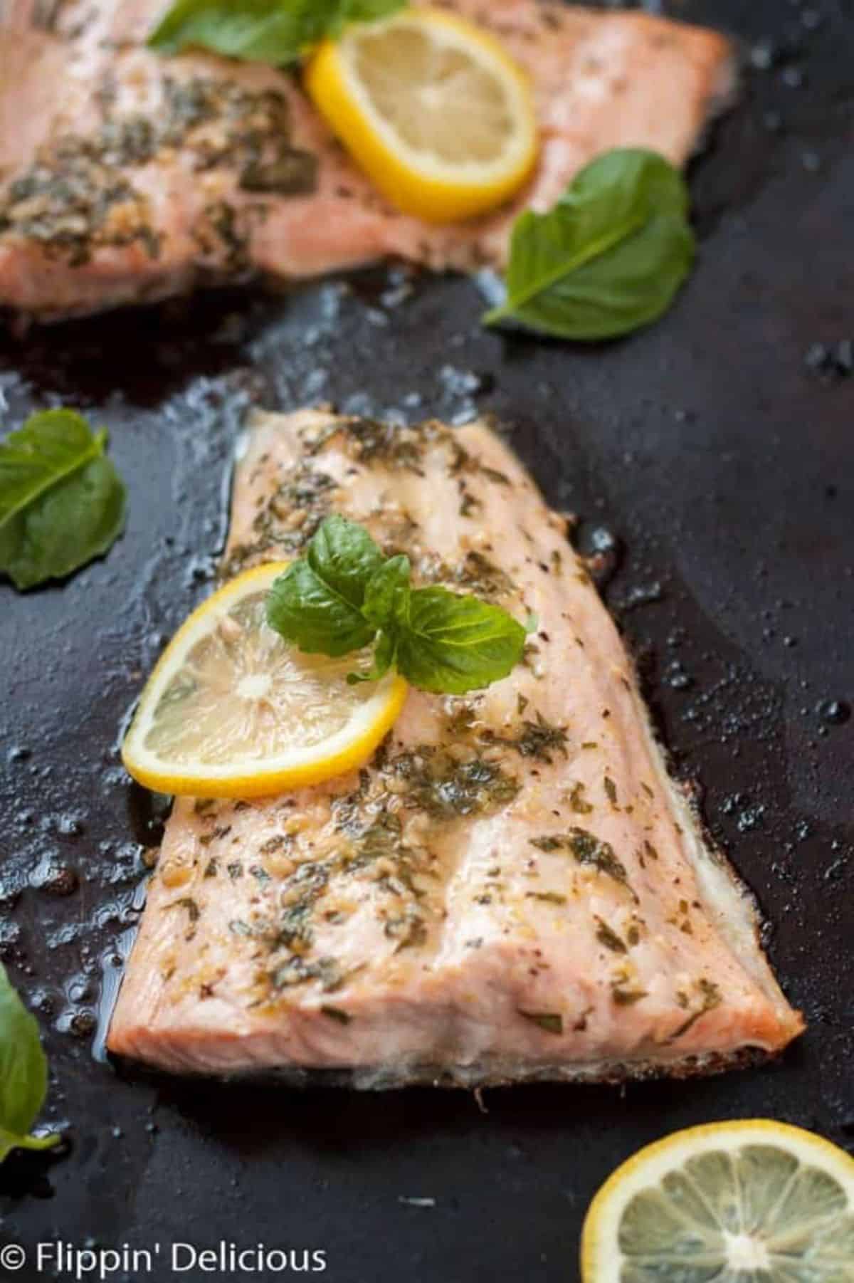 Lemon Basil Salmon steaks on a black skillet.