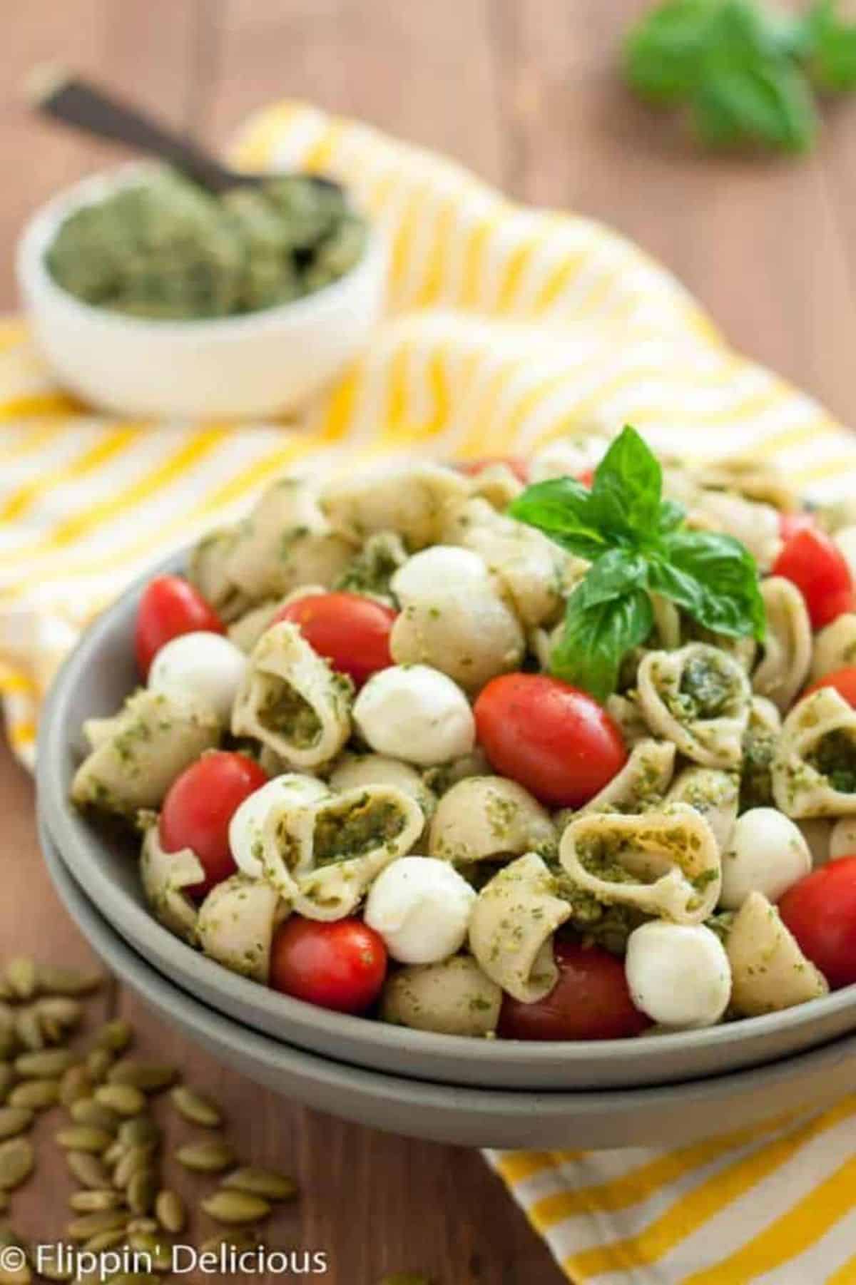 Gluten-Free Pasta Salad With Pumpkin Seed Pesto on a gray plate.