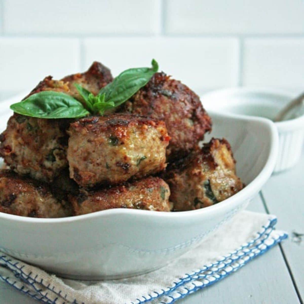 Delicious Caprese Meatballs in a white bowl.