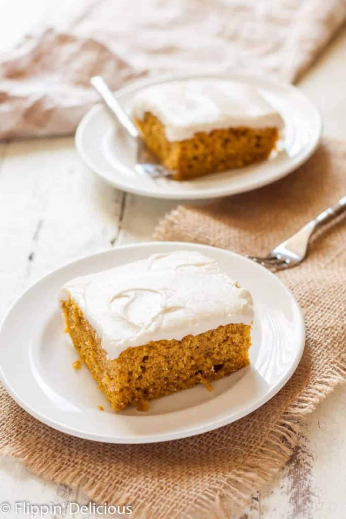 Pieces of Gluten-Free Pumpkin Cake on white plates.