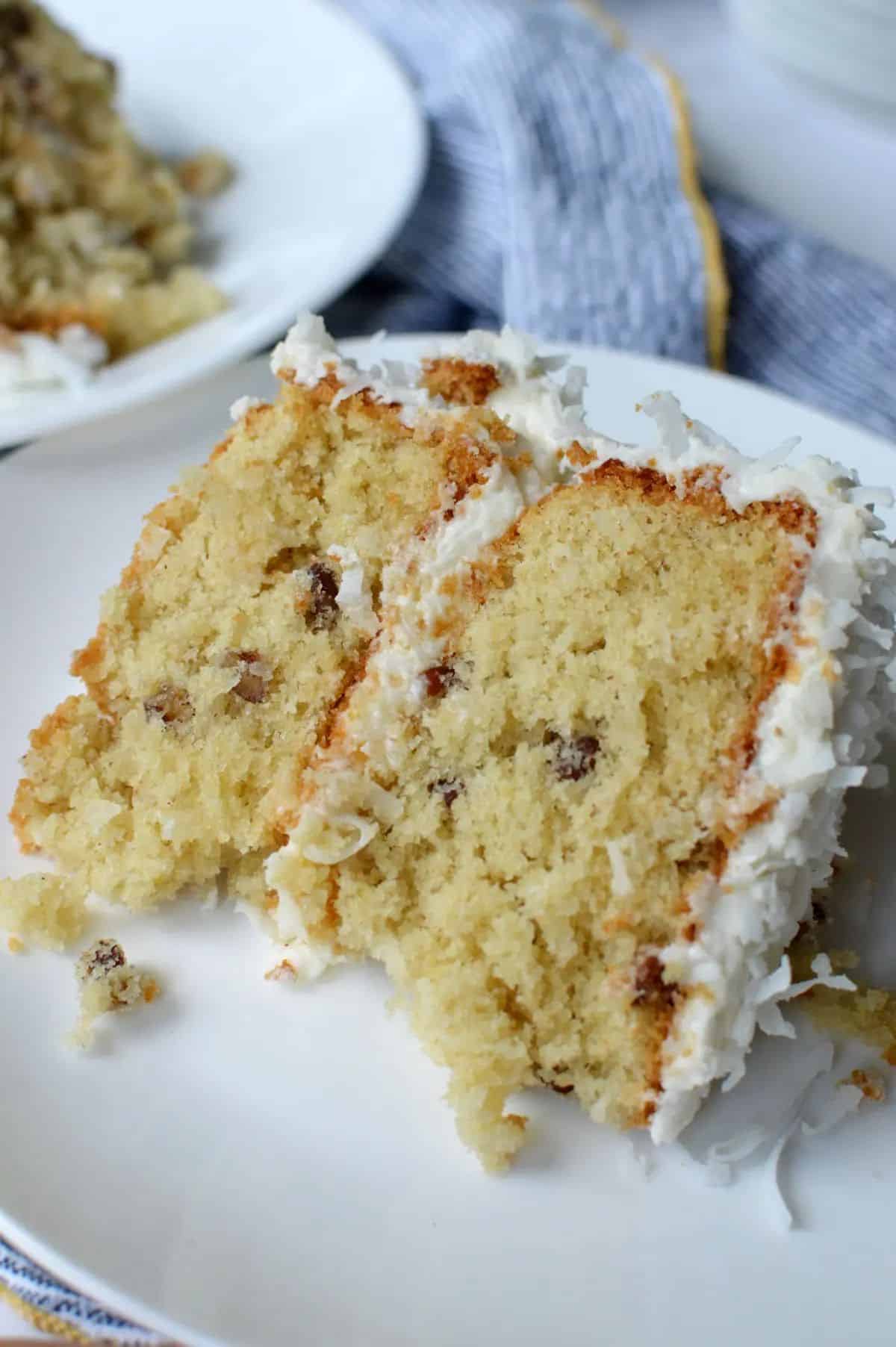 A piece of Gluten-Free Italian Cream Cake on a white plate.