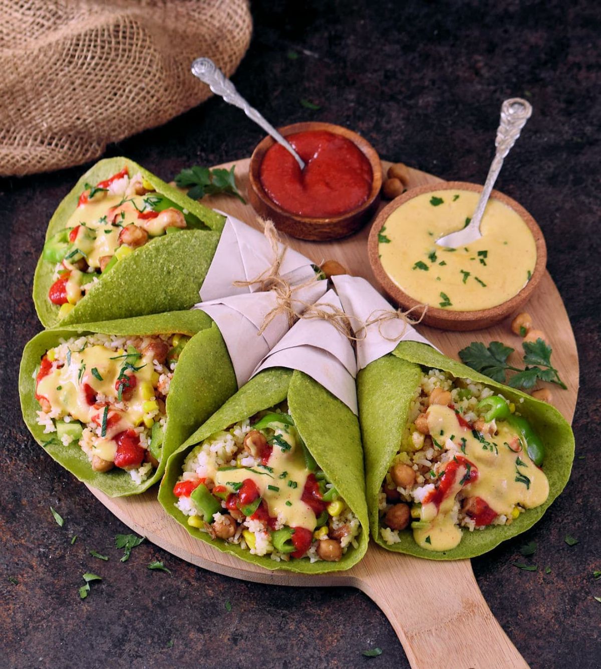 Easy Spinach Tortillas with dips in bowl on a wooden tray.