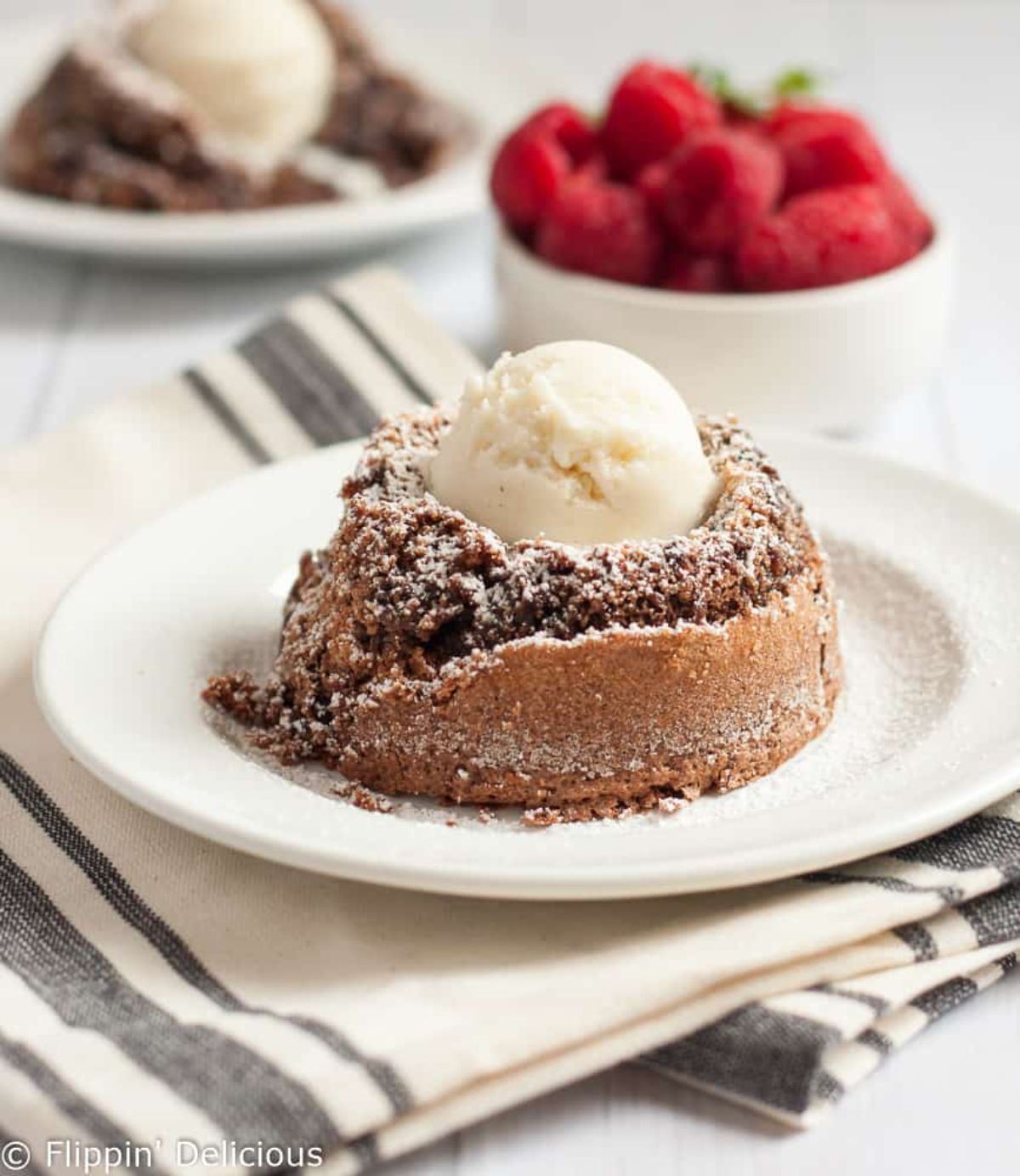 Delicious Flourless Molten Chocolate Lava Cake on a white plate.