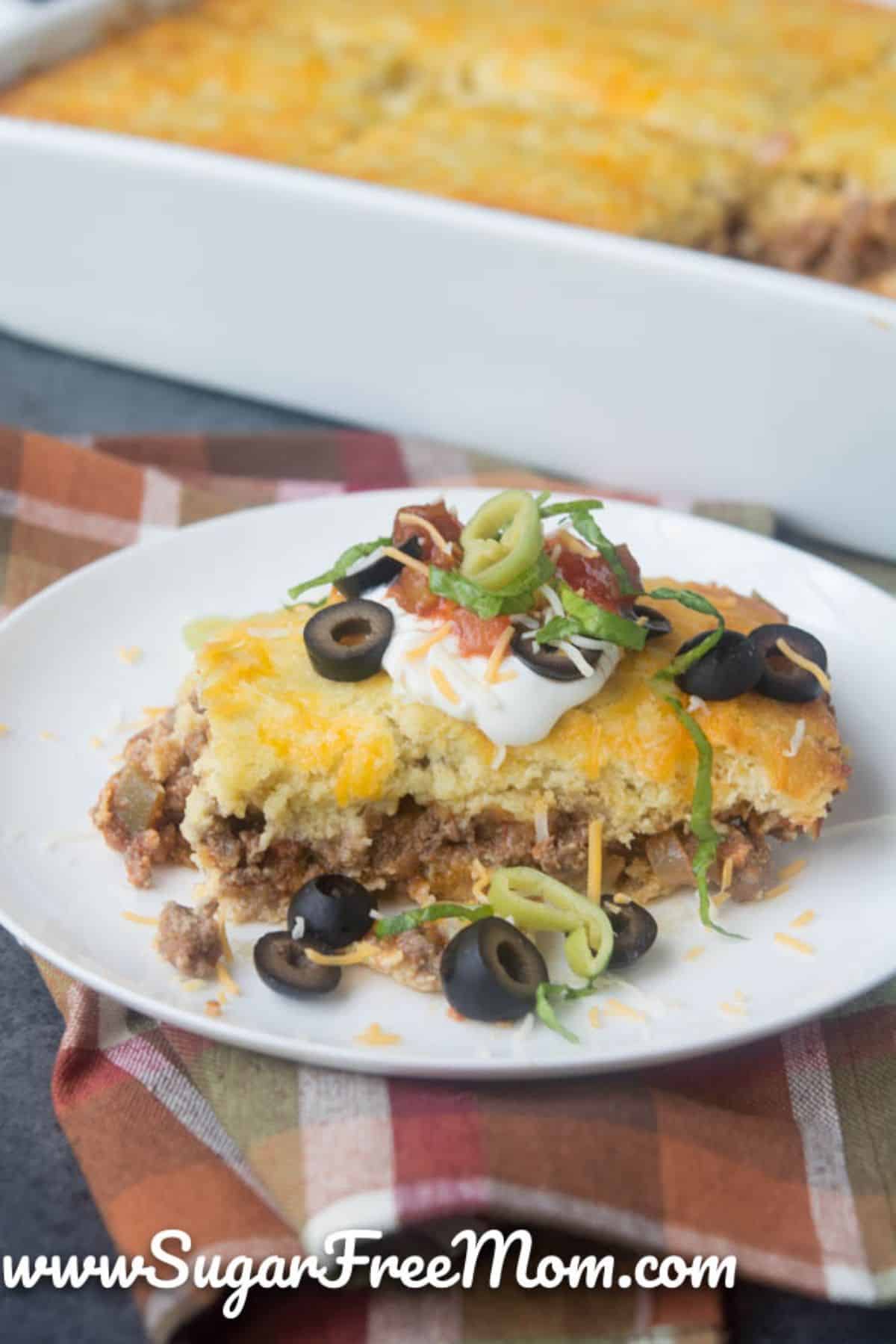 A piece of Mexican Cornbread on a white plate.