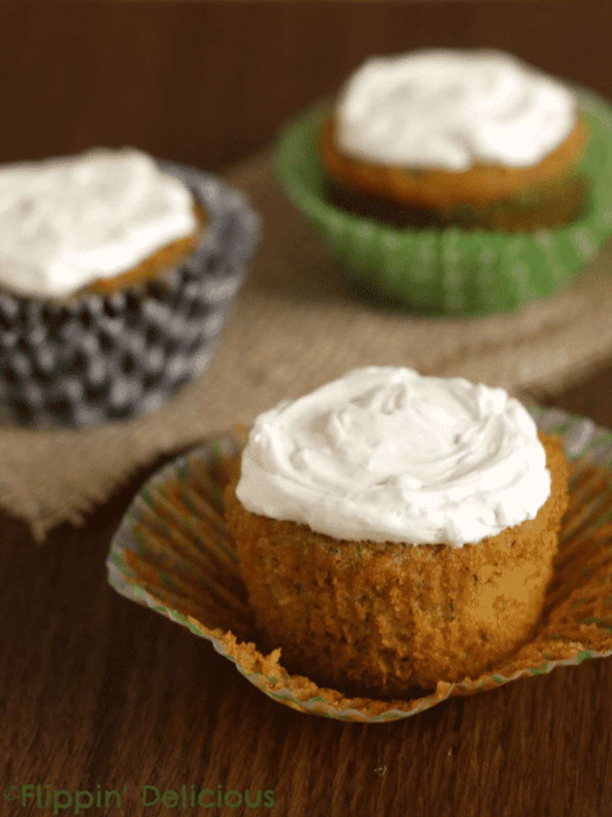 Delicious Gluten-Free Carrot Zucchini Muffins on a wooden table.