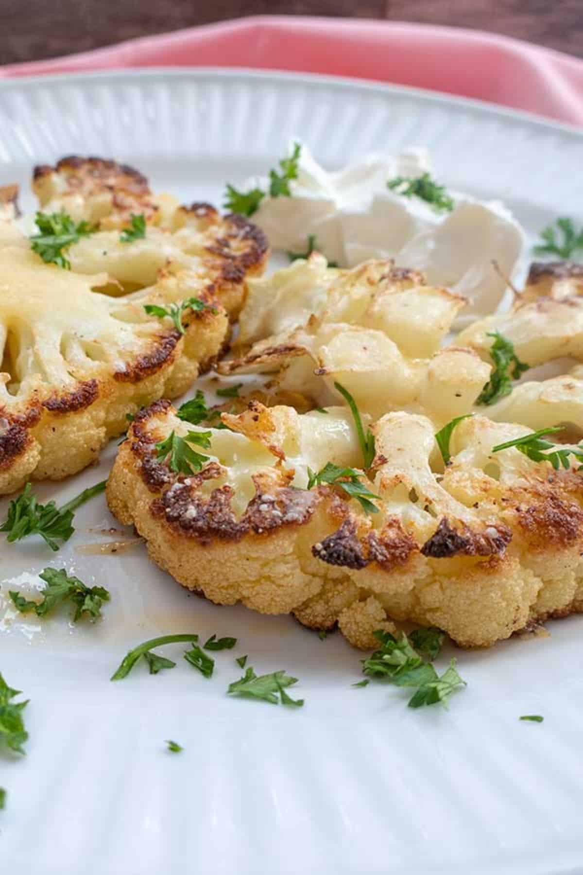 Vegan Cauliflower Steak with Cashew Sauce on a white plate.