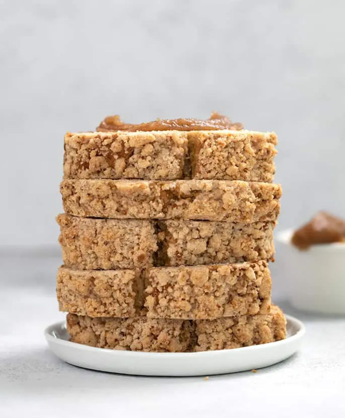 A pile of Gluten-Free Apple Bread on a white plate.