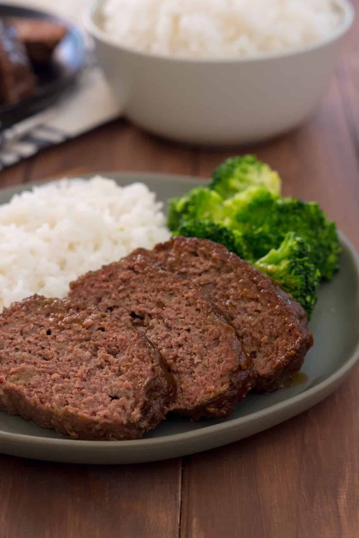 Delicious Instant Pot Gluten Free Teriyaki Meatloaf with rice and broccoli on a gray plate.