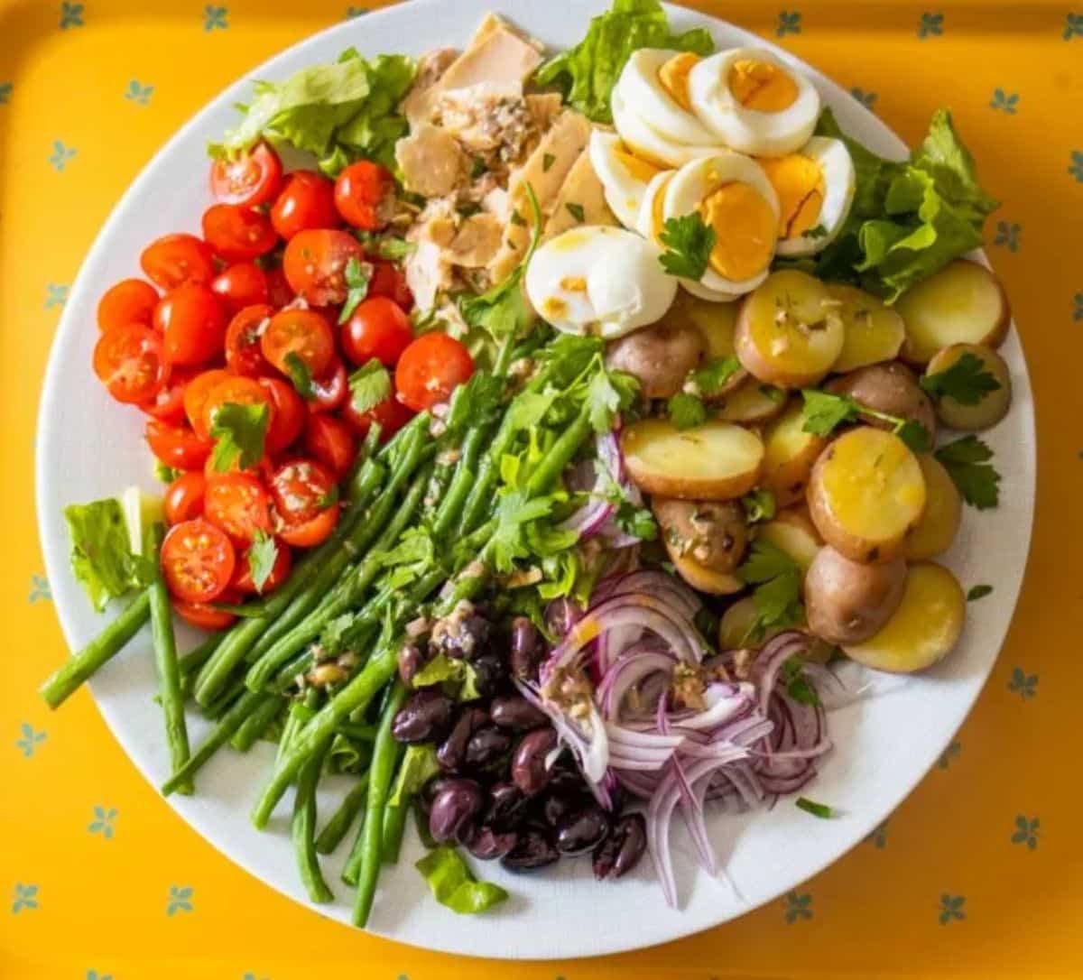 Healthy gluten-free Salade Nicoise on a white plate.