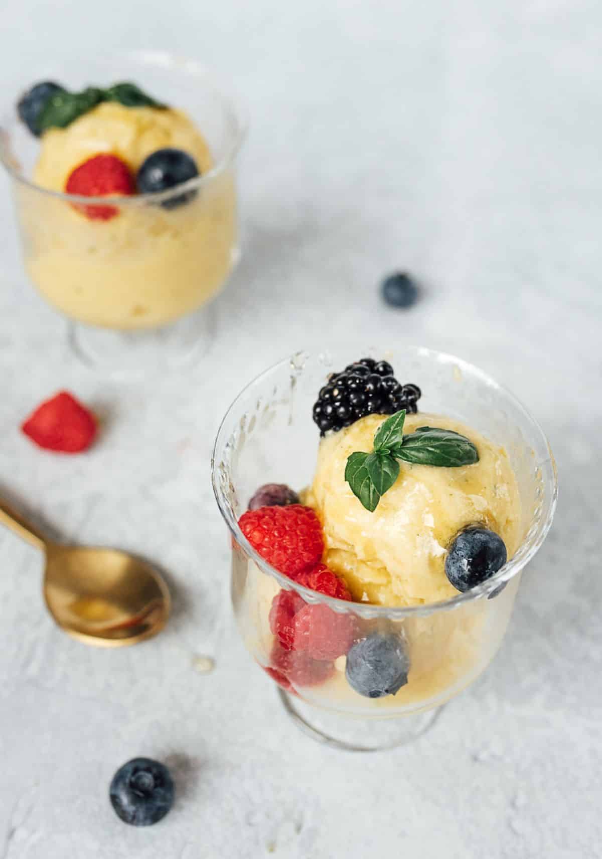 Yummy Mango Basil No-Churn Ice Cream in two glasses.