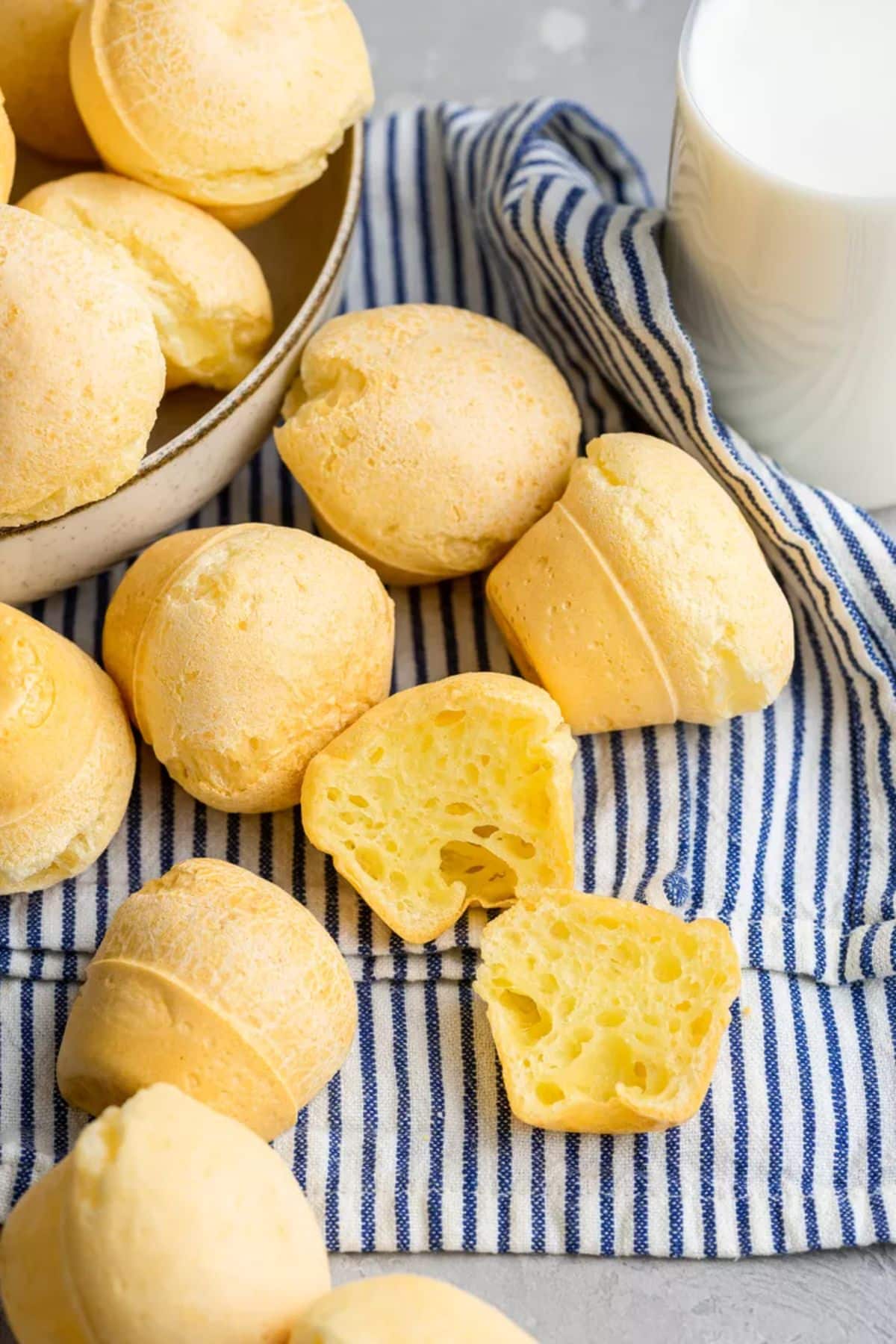 Tasty Easy Brazilian Cheese Breads scattered on a table.