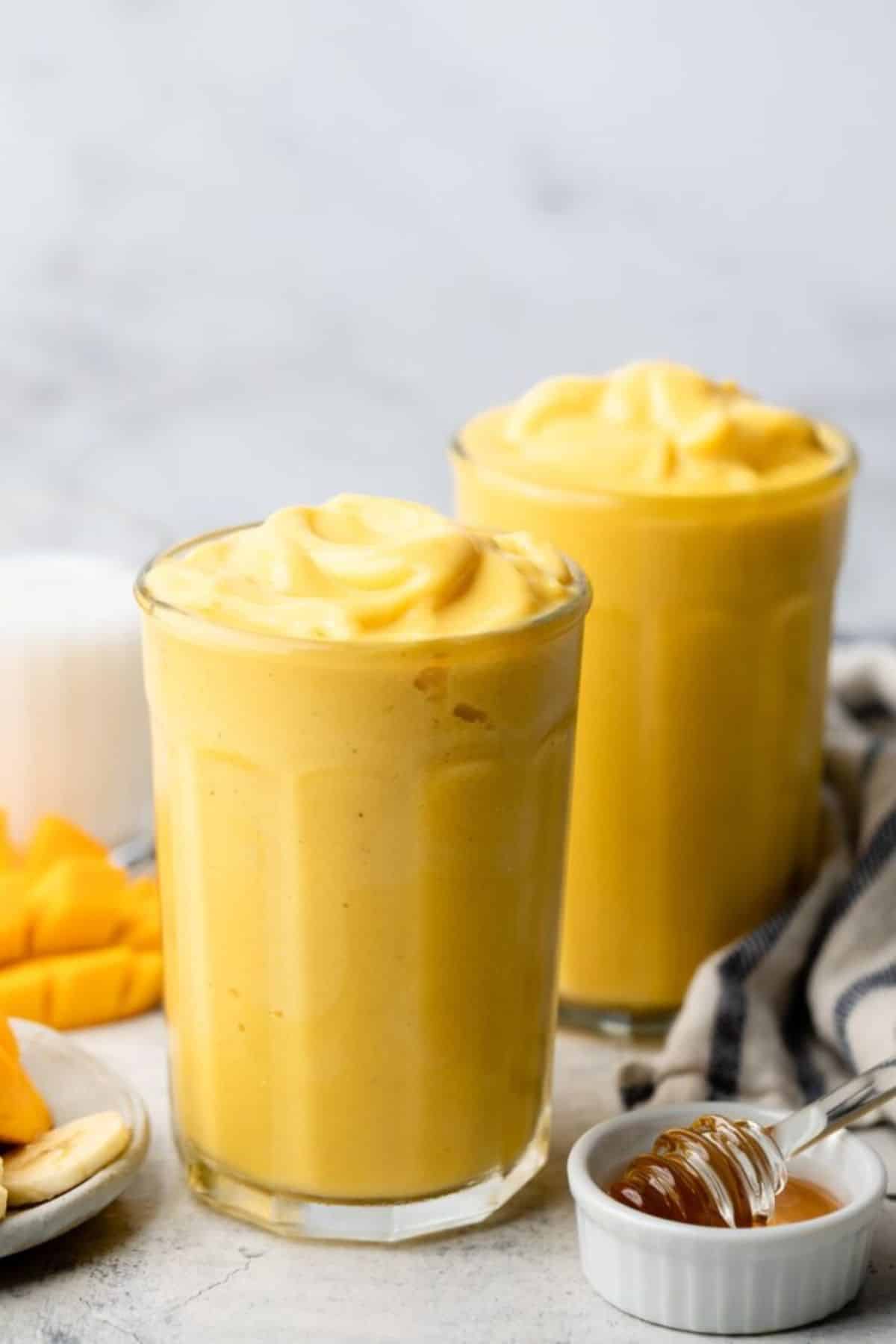Delicious Mango Coconut Smoothie in two glass cups.
