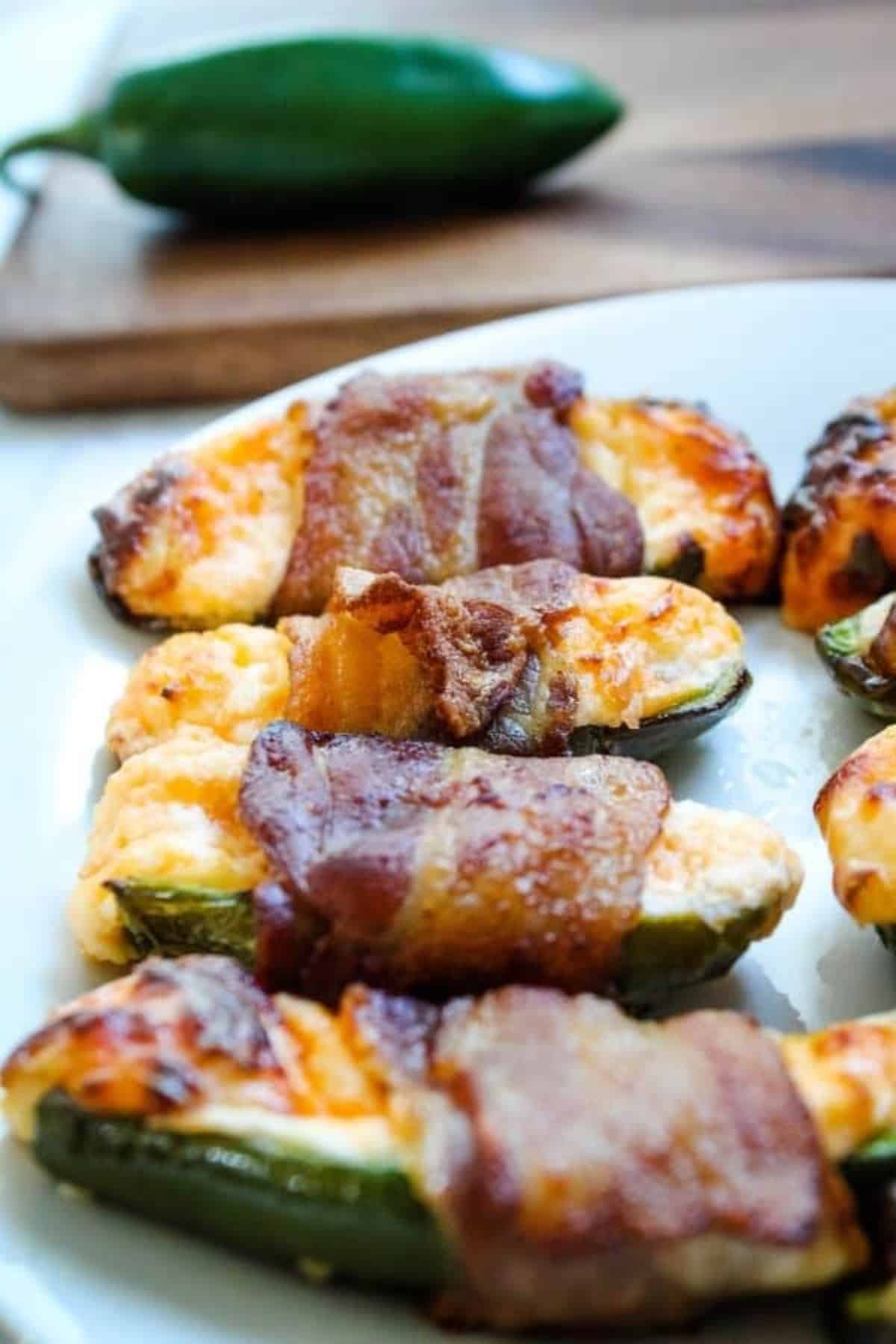 Crunchy Bacon-Wrapped Stuffed Jalapenos on a white plate.