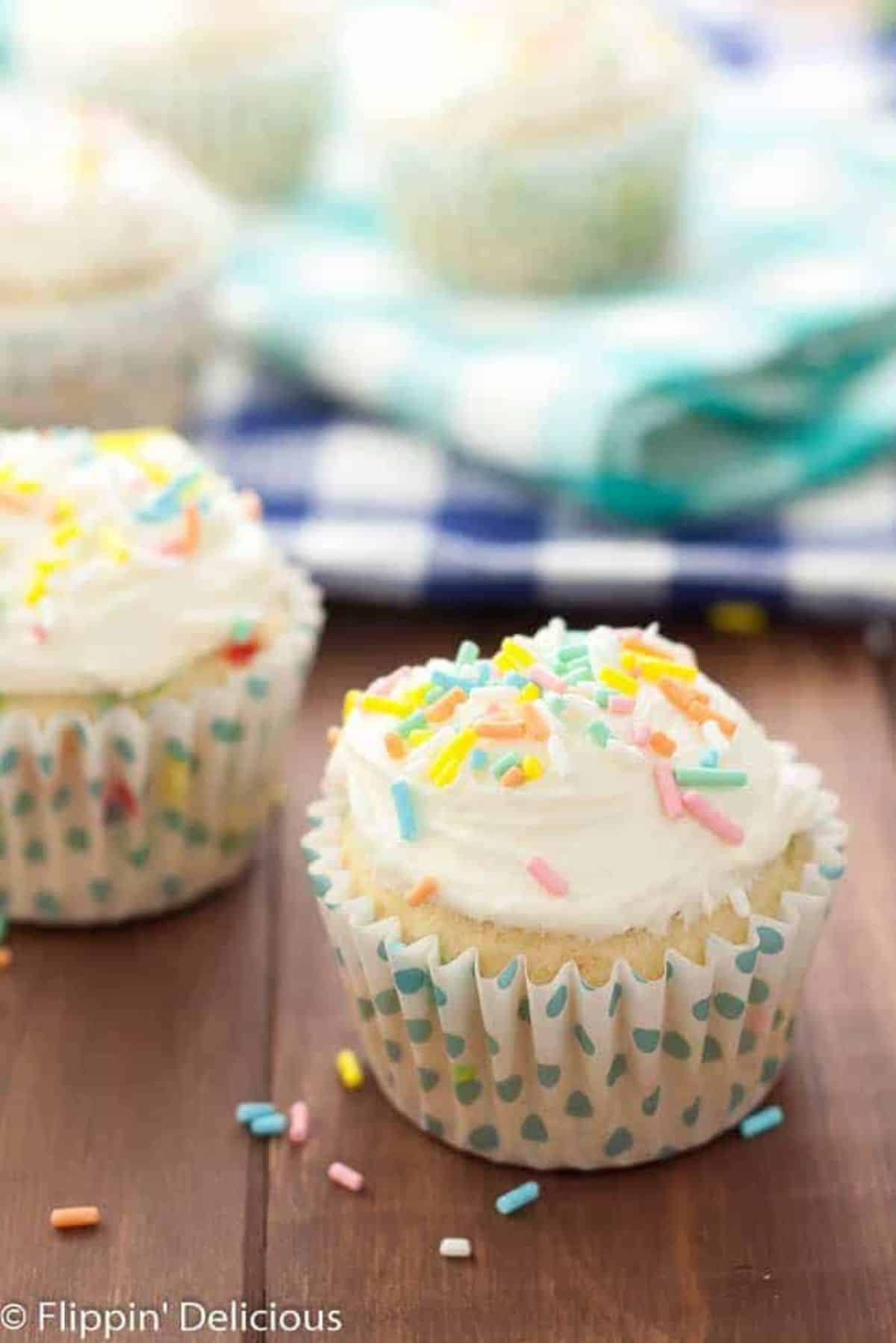 Tasty Funfetti Cupcakes with Cake Batter Frosting on a wodoen table.