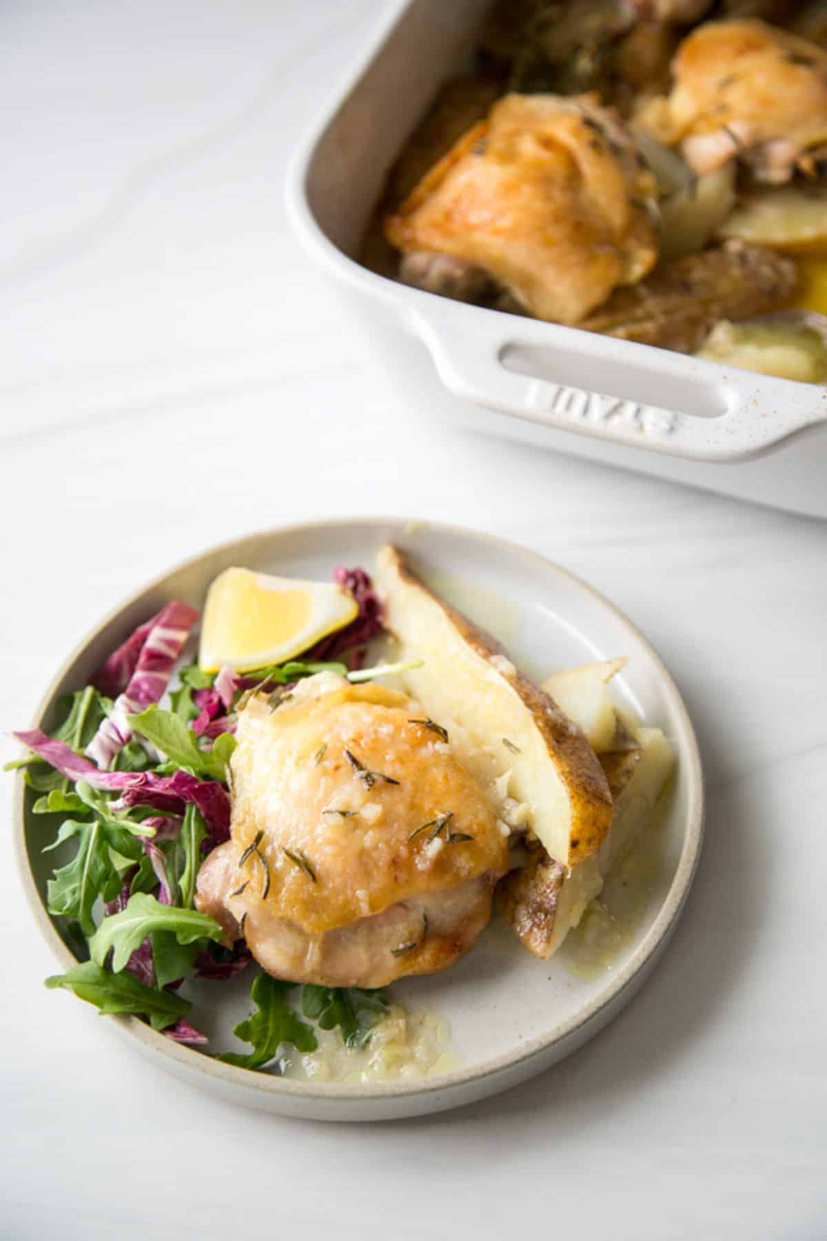 Scrumptious Greek Lemon Chicken and Potatoes on a white plate.