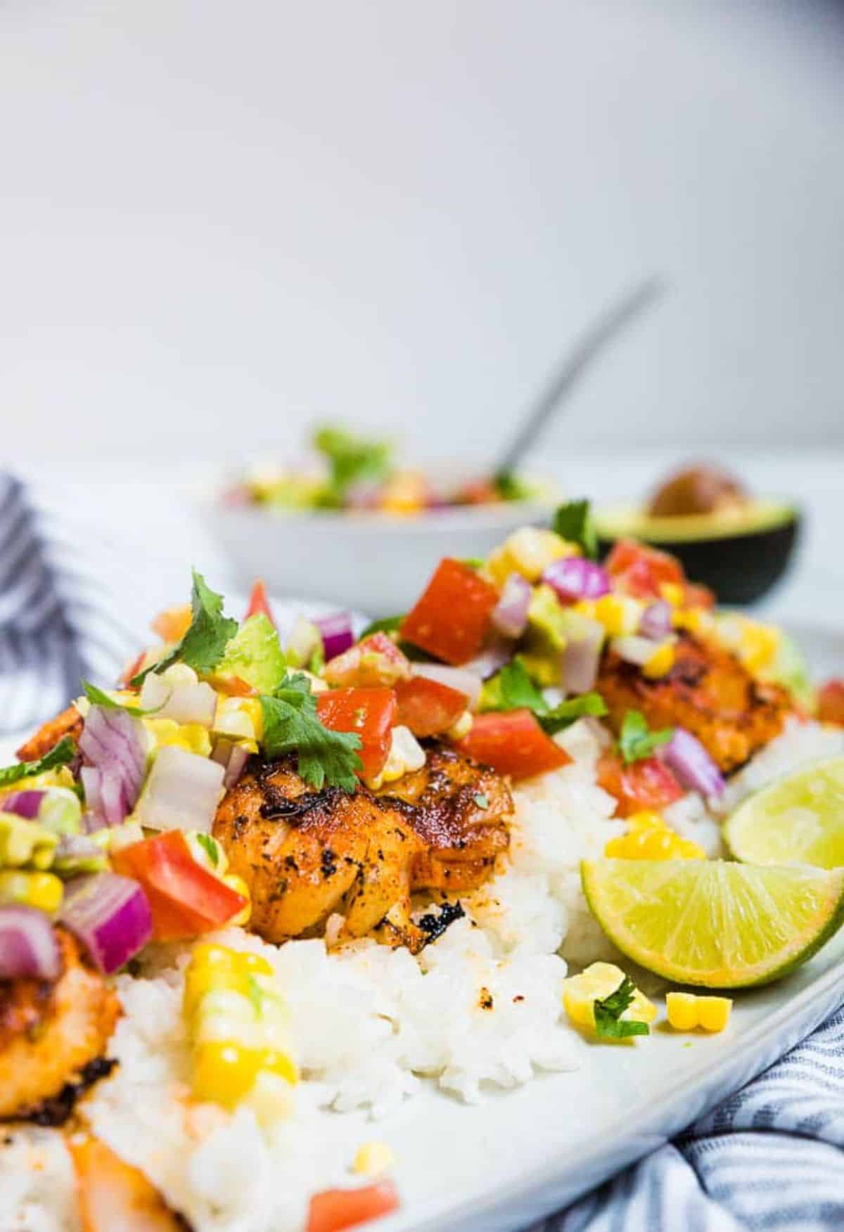 Delicious Blackened Cod with Avocado Corn Salsa on a tray.