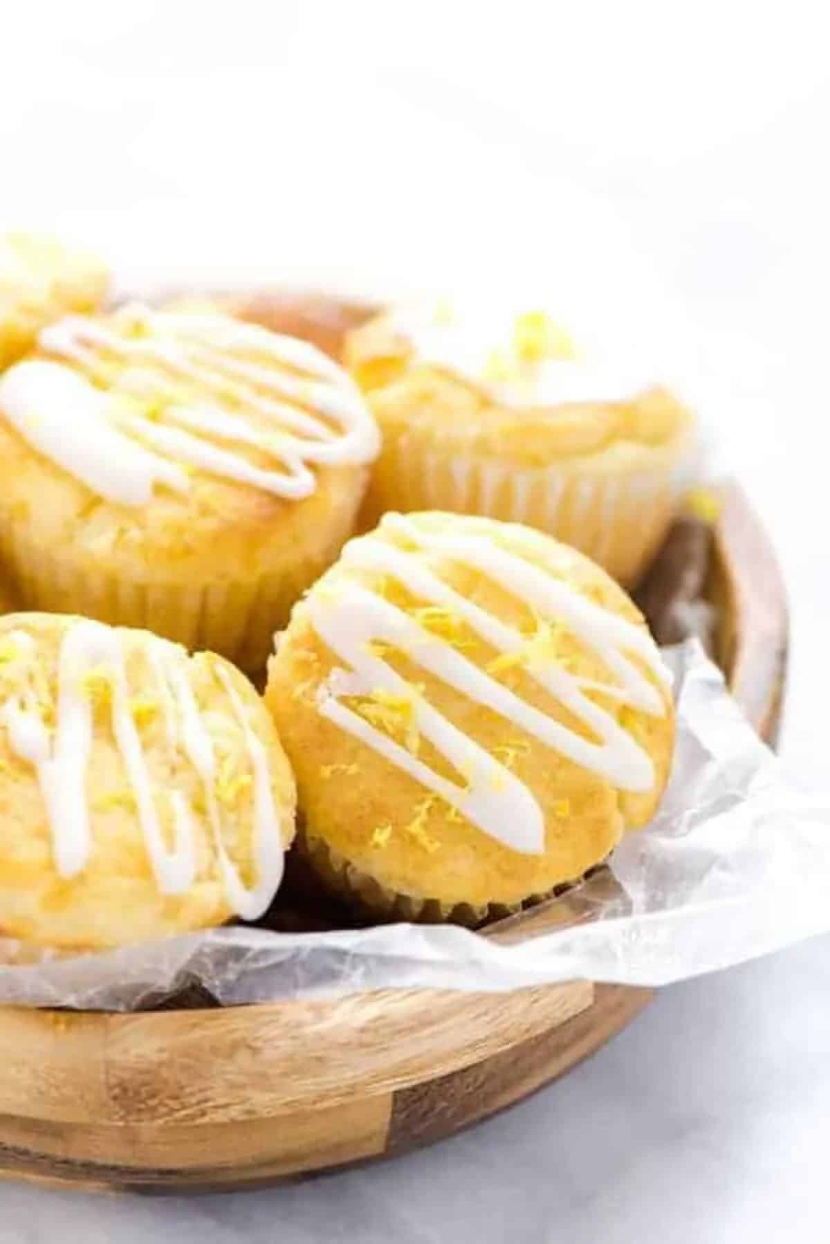 Flavorful Gluten-Free Lemon Ricotta Muffins in a wooden bowl.